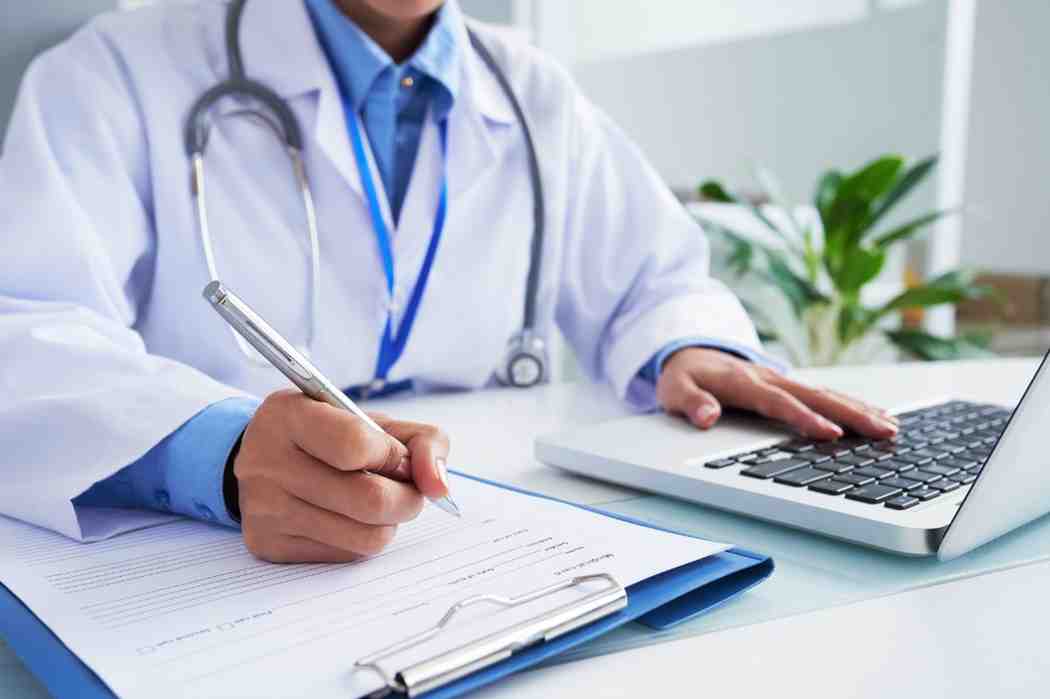 Medical professional reviewing complex medical reports